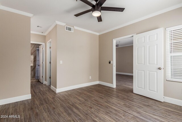 unfurnished bedroom with ceiling fan, dark hardwood / wood-style floors, and crown molding