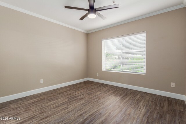 unfurnished bedroom featuring a walk in closet, dark hardwood / wood-style flooring, a closet, crown molding, and ceiling fan