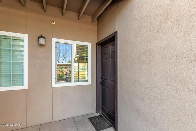 entrance to property with stucco siding