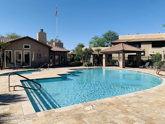 view of pool featuring french doors and a patio