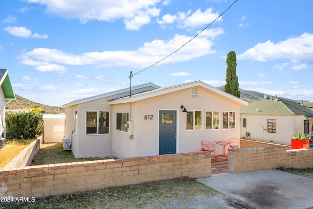 view of front of home featuring a patio and a mountain view