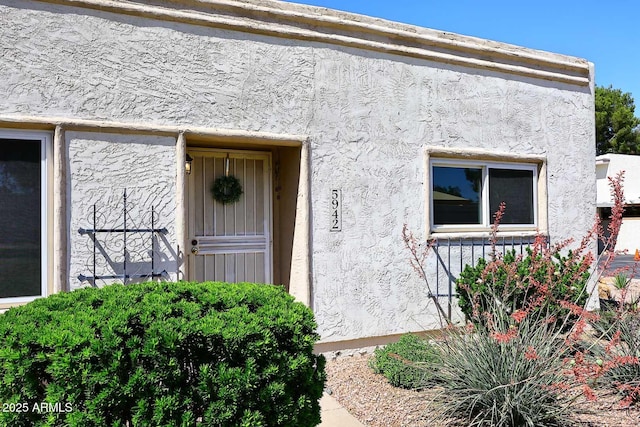 view of exterior entry with stucco siding