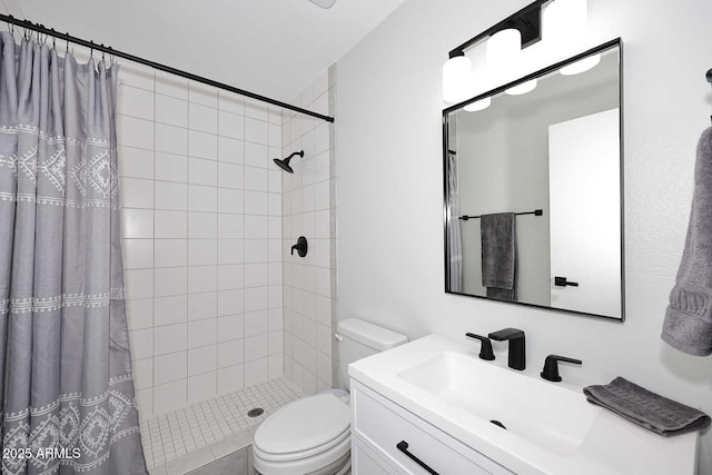 full bathroom with vanity, toilet, and tiled shower