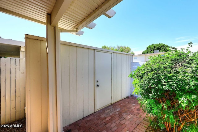view of shed featuring fence