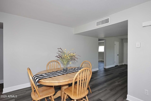 dining space with visible vents, baseboards, and dark wood-style flooring