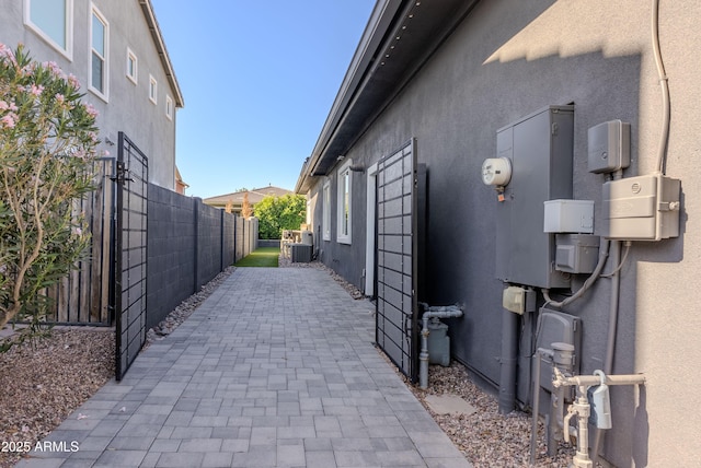 3145 E Boot Track Trl, Gilbert, AZ 85296 - view of property exterior featuring stucco siding, central air condition unit, and a patio area