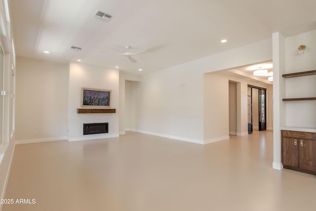 3145 E Boot Track Trl, Gilbert, AZ 85296 - unfurnished living room featuring a ceiling fan, a glass covered fireplace, recessed lighting, baseboards, and concrete flooring