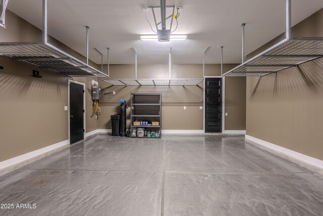 3145 E Boot Track Trl, Gilbert, AZ 85296 - garage with baseboards and a garage door opener