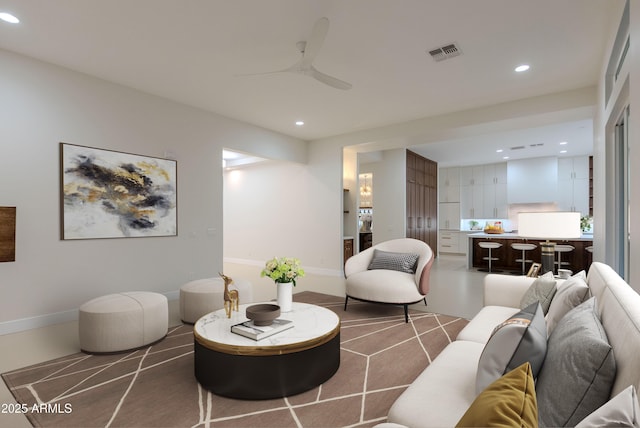 living area featuring recessed lighting, ceiling fan, and visible vents