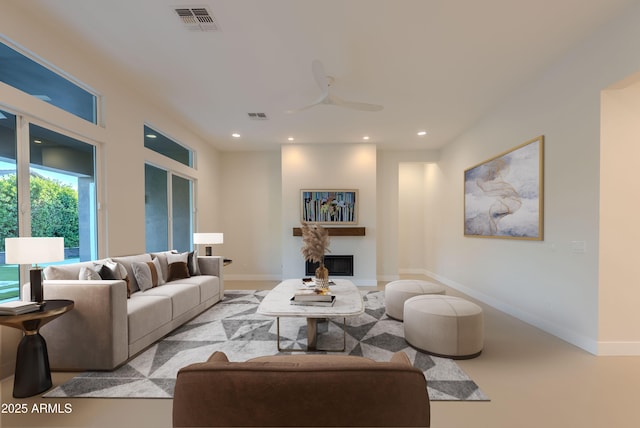 living room featuring recessed lighting, ceiling fan, visible vents, and a glass covered fireplace
