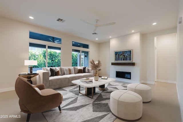 living area featuring recessed lighting, ceiling fan, visible vents, and a glass covered fireplace