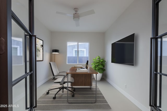 office space featuring baseboards and a ceiling fan