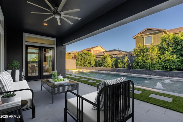 view of patio / terrace featuring ceiling fan, a fenced in pool, french doors, and a fenced backyard