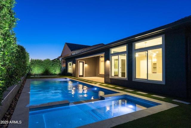 view of swimming pool with a pool with connected hot tub