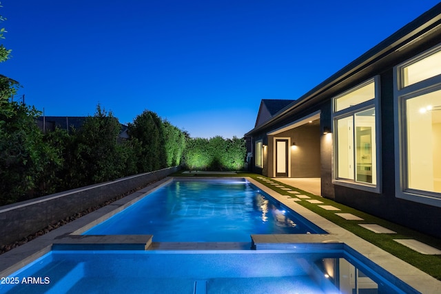 view of pool with a fenced in pool and an in ground hot tub