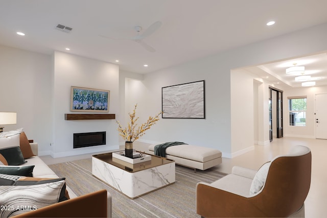 living room featuring recessed lighting, a ceiling fan, visible vents, and a glass covered fireplace