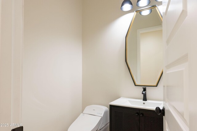 half bath featuring toilet and vanity