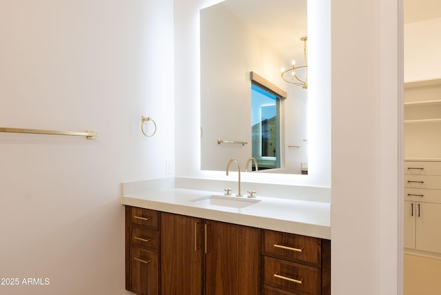 bathroom with a notable chandelier and vanity