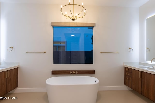 full bathroom featuring baseboards, two vanities, and a notable chandelier