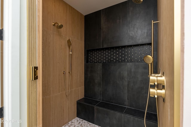 bathroom with a tile shower
