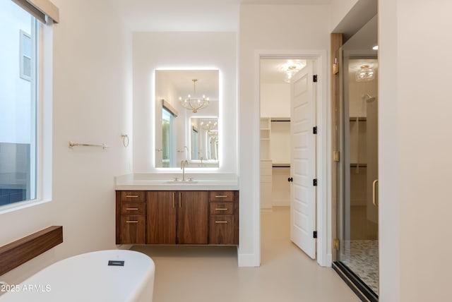 full bath featuring vanity, a chandelier, a shower stall, a spacious closet, and a soaking tub