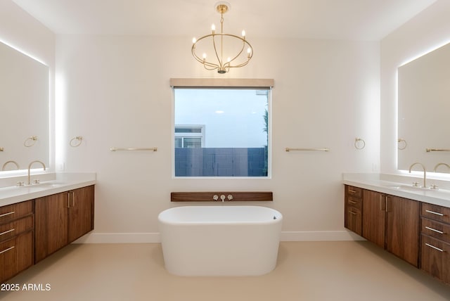 full bathroom featuring baseboards, a sink, and two vanities