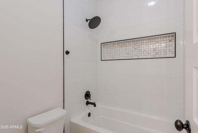 bathroom featuring shower / bath combination and toilet