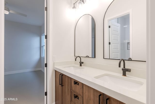 full bathroom with double vanity, ceiling fan, and a sink