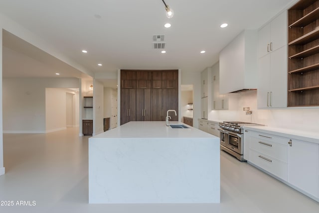 kitchen featuring open shelves, modern cabinets, recessed lighting, range with two ovens, and a sink