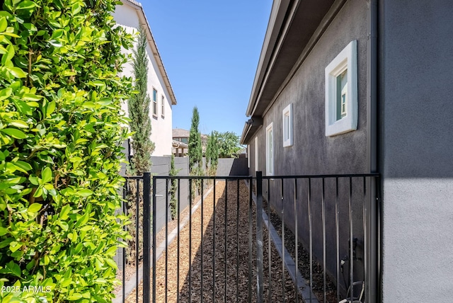 view of home's exterior featuring fence and stucco siding