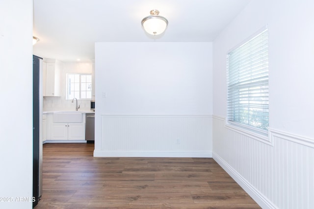 1006 S Una Ave, Tempe, AZ 85281 - unfurnished dining area with a wainscoted wall and dark wood-style floors