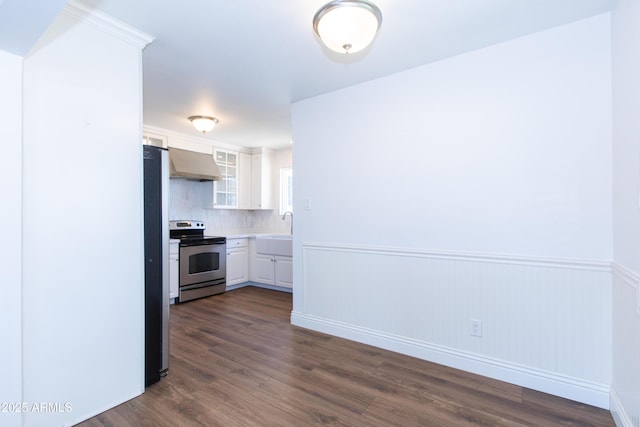 1006 S Una Ave, Tempe, AZ 85281 - kitchen with stainless steel appliances, wall chimney exhaust hood, white cabinets, dark wood-style floors, and a wainscoted wall
