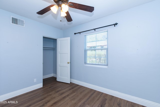 1006 S Una Ave, Tempe, AZ 85281 - unfurnished bedroom featuring a closet, dark wood finished floors, and a ceiling fan