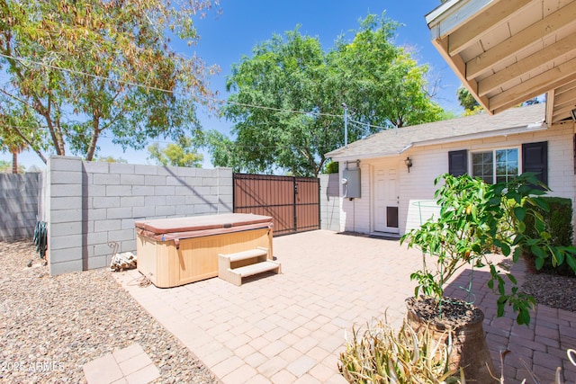 1006 S Una Ave, Tempe, AZ 85281 - fenced backyard featuring a hot tub, a patio, and a gate