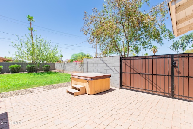 1006 S Una Ave, Tempe, AZ 85281 - fenced backyard featuring a hot tub, a patio, and a gate