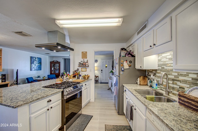 kitchen featuring light stone counters, stainless steel appliances, sink, and white cabinets