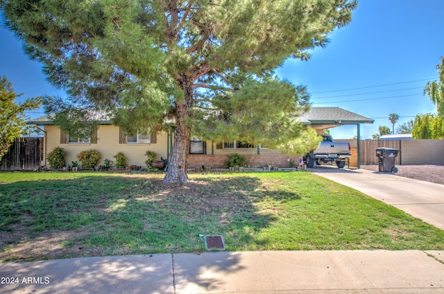 view of front of property with a carport and a front yard