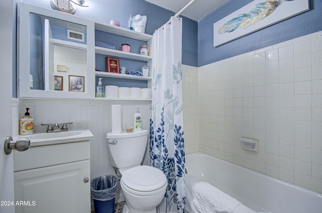 full bathroom featuring vanity, shower / bath combo with shower curtain, and toilet