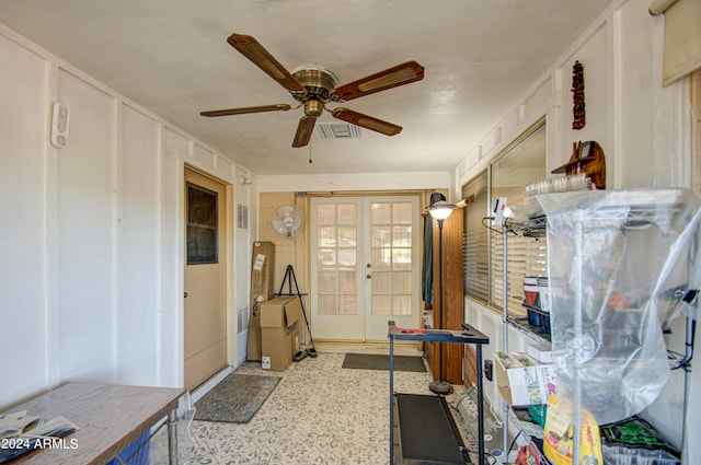 misc room with french doors and ceiling fan with notable chandelier