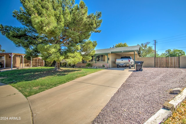 single story home featuring a front yard and a carport