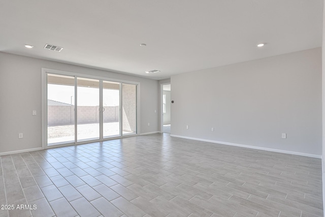 spare room with visible vents, recessed lighting, and baseboards