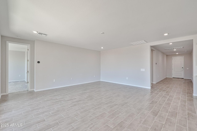 unfurnished room featuring baseboards, light wood-type flooring, recessed lighting, and visible vents