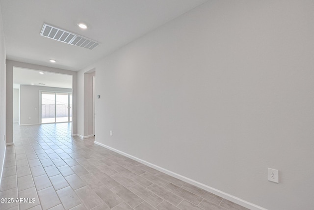 spare room featuring recessed lighting, baseboards, and visible vents