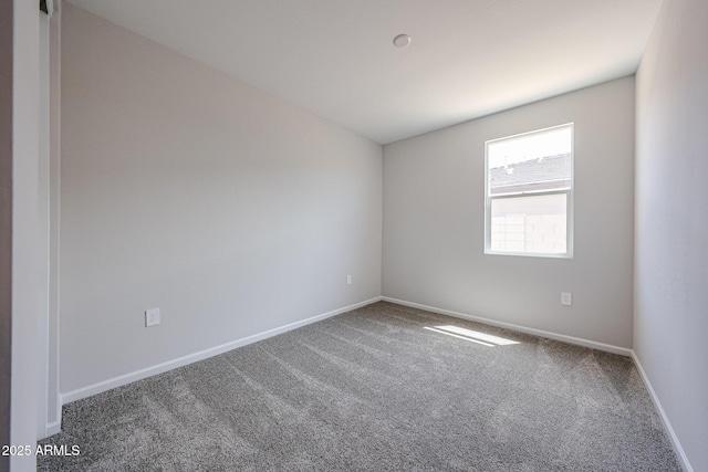 carpeted empty room with baseboards