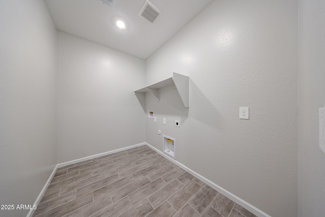 laundry room with laundry area, baseboards, hookup for a gas dryer, hookup for an electric dryer, and visible vents