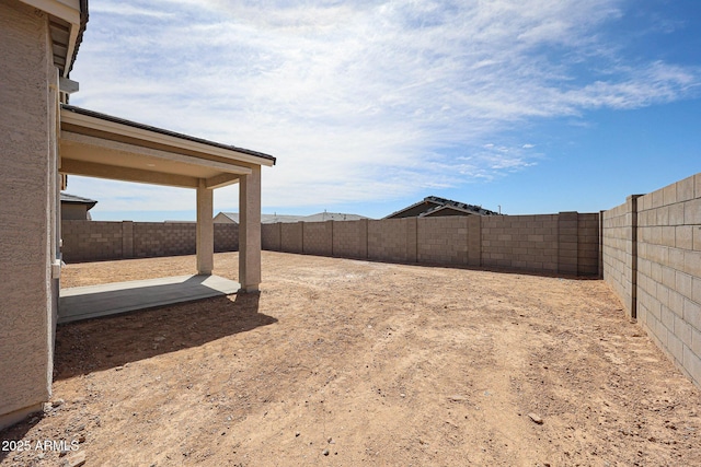view of yard with a fenced backyard and a patio