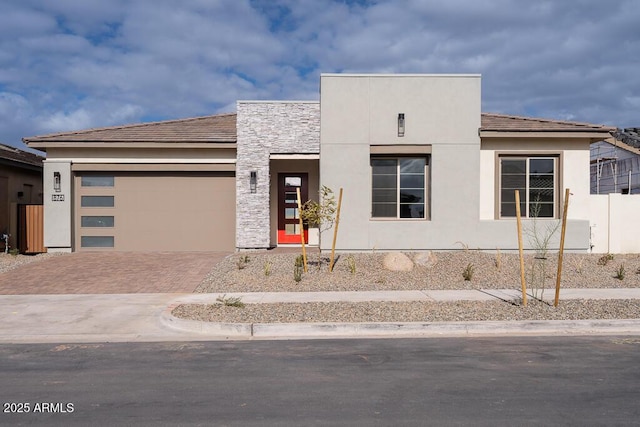 876 W Golden Ore Pass, Apache Junction, AZ 85120 - modern home featuring an attached garage, decorative driveway, and stucco siding