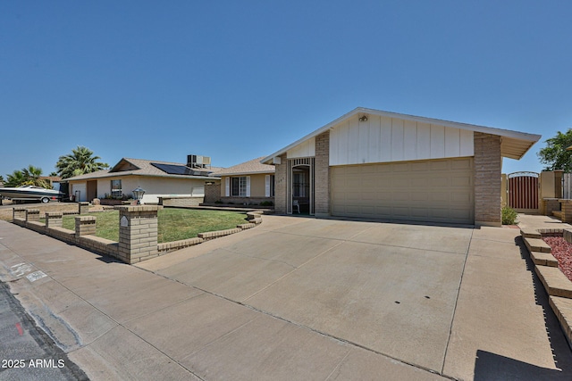 5349 W Acapulco Ln, Glendale, AZ 85306 - ranch-style home with a garage, brick siding, a gate, and driveway