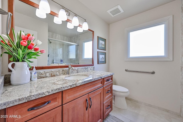 5349 W Acapulco Ln, Glendale, AZ 85306 - bathroom with healthy amount of natural light, tiled shower, vanity, and tile patterned flooring