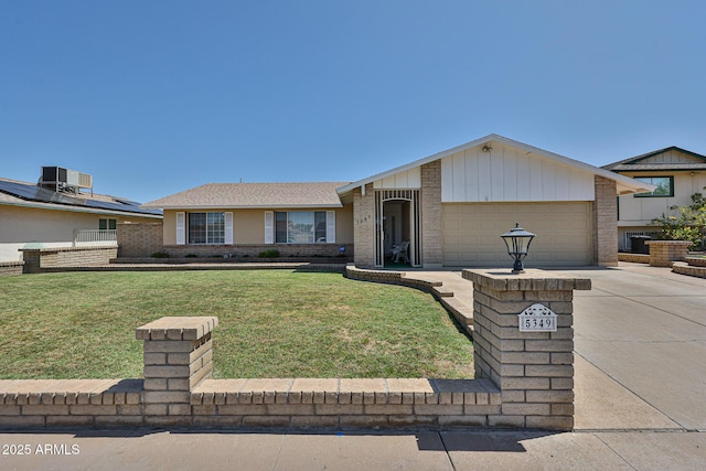 5349 W Acapulco Ln, Glendale, AZ 85306 - ranch-style home with driveway, an attached garage, brick siding, and a front lawn